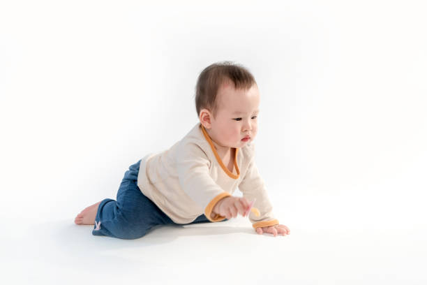 istock Cute baby sitting playing with color models in white background 953517576