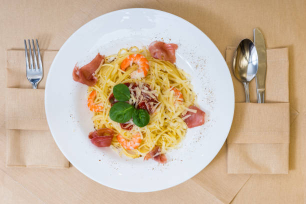 istock High angle view of spaghetti pasta in white plate on decorated table with light tablecloth 953517816