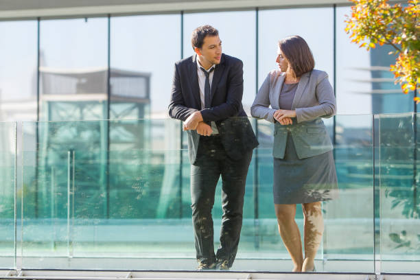 istock Serene calm business colleagues leaning on glassy railing 953518960