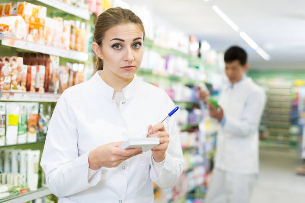 istock female pharmacist is inventorying medicaments 953519028