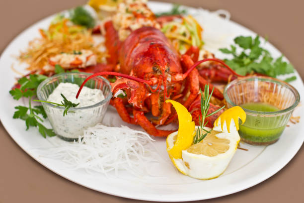 istock Lobster served with the vegetables on a white plate. Isolated 953521324