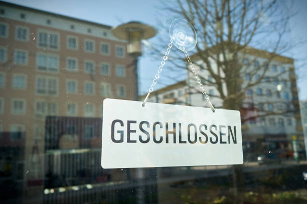 Sign with the inscription closed at the window of a shop Sign with the inscription closed at the window of a shop in germany closed sign stock pictures, royalty-free photos & images