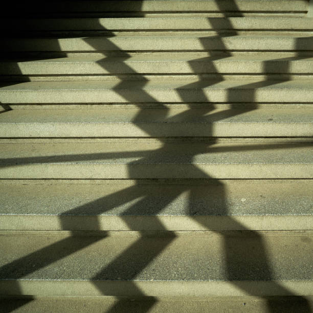 istock Shadow of a window grille in a staircase 953522676