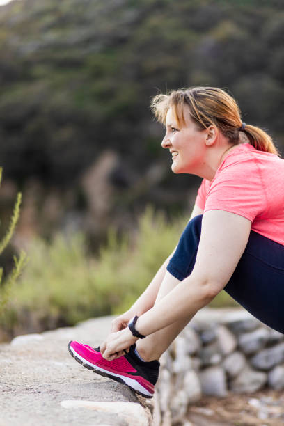 istock Diverse Couple Walking Active Lifestyle Tying Shoe 953525134