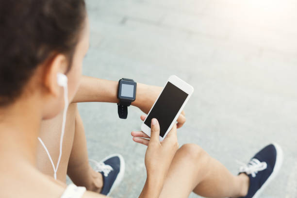 istock Image of a woman using smartphone with blank screen outdoors 953525284