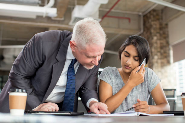 istock Focused business leader supervising managers work 953526756