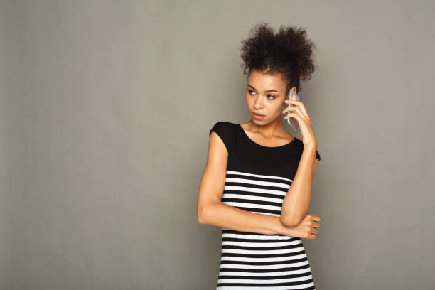 istock Serious beautiful woman talking on phone 953527928