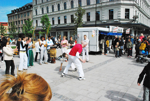 Spectators watch a capoeira demonstration during a national day celebration (6th of May).