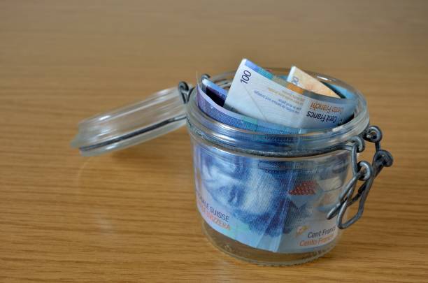 istock Old jar with Swiss franc bills 953530798