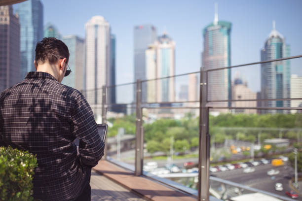 istock Lovely Picturesque Shanghai And Businessman Using Lapotop 953530864