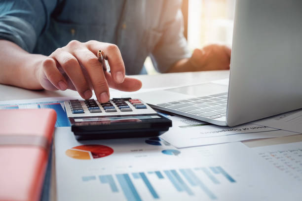 istock Business accounting concept, Business man using calculator with computer laptop, budget and loan paper in office. 953533708