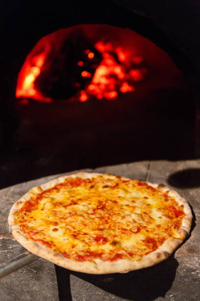 istock Fresh baked pizza with cheese near oven 953534662