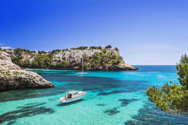 Beautiful bay in Mediterranean sea with sailing boats Beautiful bay with sailing byachts, Cala Galdana, Menorca island, Spain balearic islands stock pictures, royalty-free photos & images