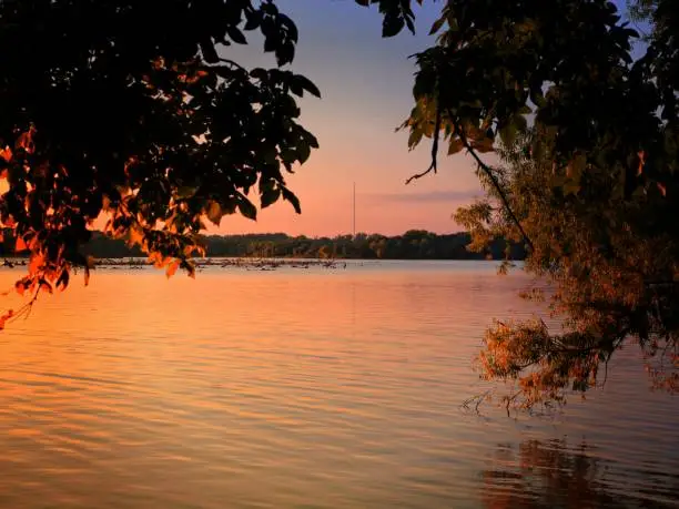 Sunset colors reflected in the waters of the lake at twilight