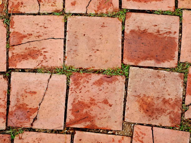 istock Uneven pavement of red bricks 953537710