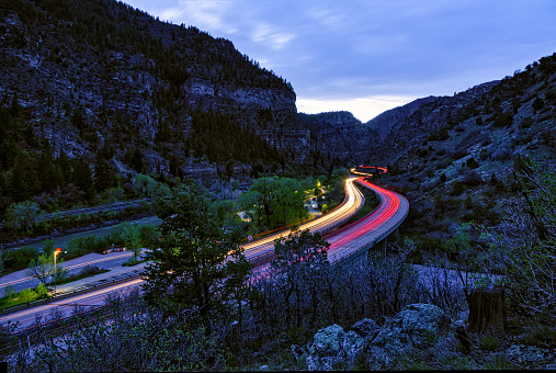 Driving at Night Through Glenwood Canyon - Scenic view at night blue hour of vehicle lights during time exposure.