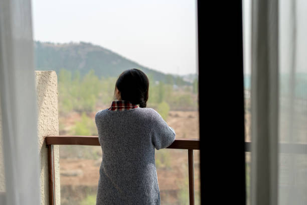 istock girl looking at view on balcony 953578072