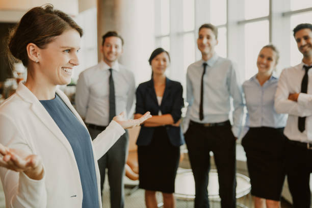 istock Smiling Businesswoman with Team 953579184