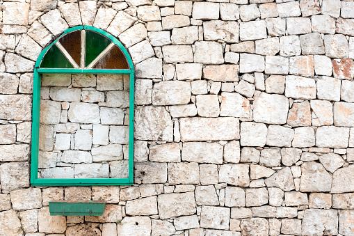 Old green window, dirty and rustic stone background