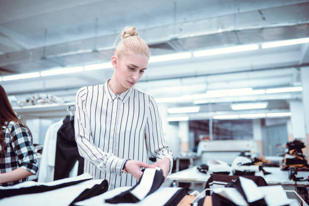 istock Cute Girl is Measuring Clothes at Work 953584484