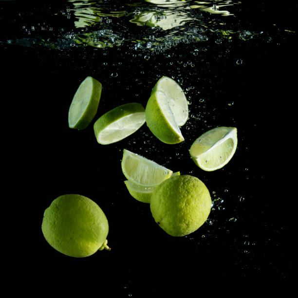 istock Fresh limes are dropped into water. 953587976