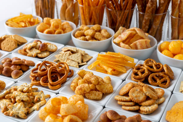 istock Rows of many types of savory snacks in white ceramic dishes. 953588422