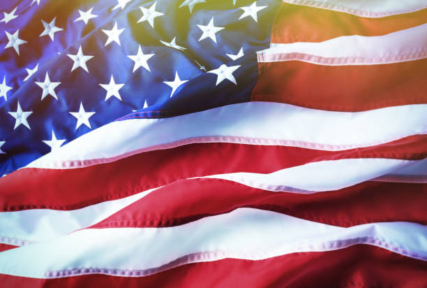 istock American flag background. Brightly lit American flag. Sunlight, sunflare. 953597620