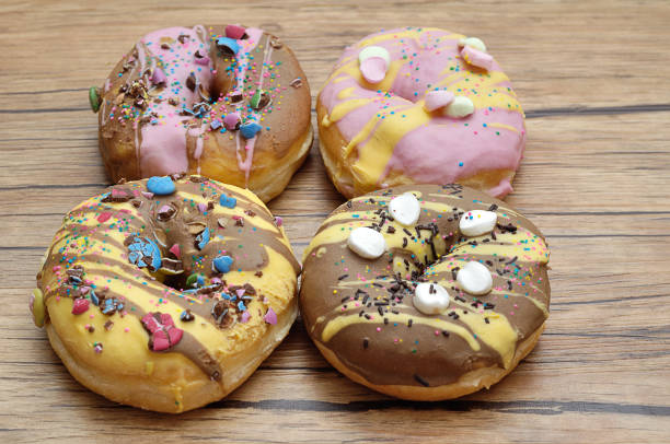 istock Decorated doughnuts on a wooden background 953607166