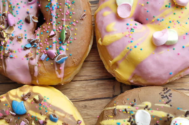 istock Decorated doughnuts on a wooden background 953607342
