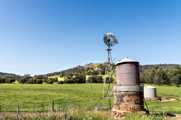 istock Old Windmill and Water Tank on a farm 953611870