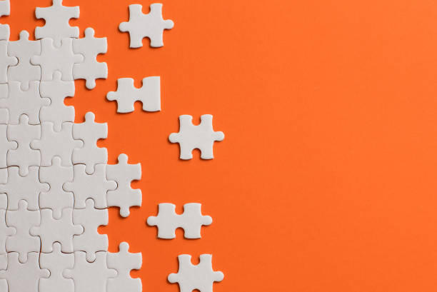 istock White details of puzzle on orange background 953620886
