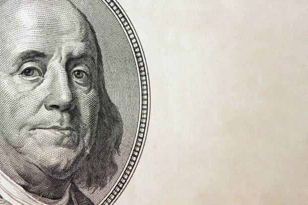 istock Dollars closeup. Benjamin Franklin's portrait on one hundred dollar bill with copy space 953621002