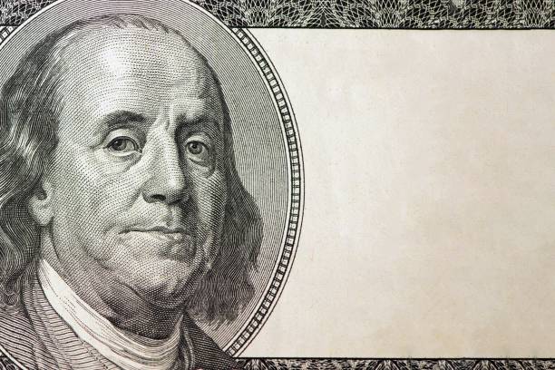 istock Dollars closeup. Benjamin Franklin's portrait on one hundred dollar bill with copy space 953621006