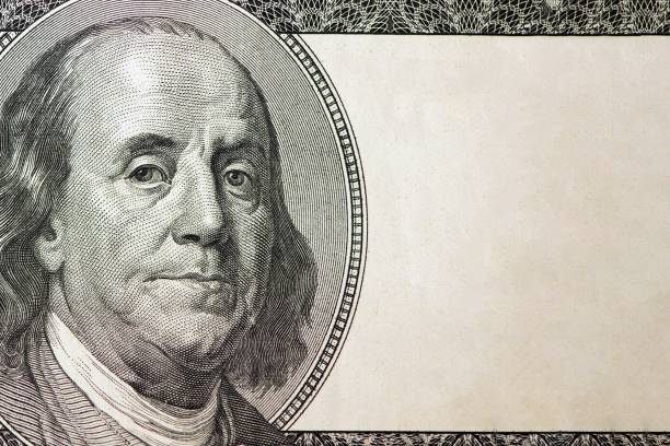 Dollars closeup. Benjamin Franklin's portrait on one hundred dollar bill with copy space stock photo