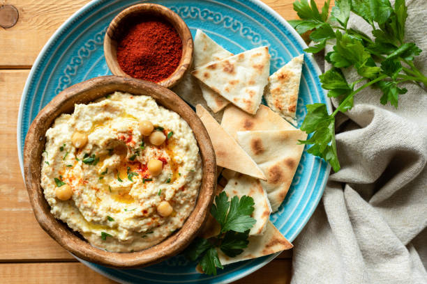 istock Chickpea hummus, pita chips, paprika and parsley 953628264