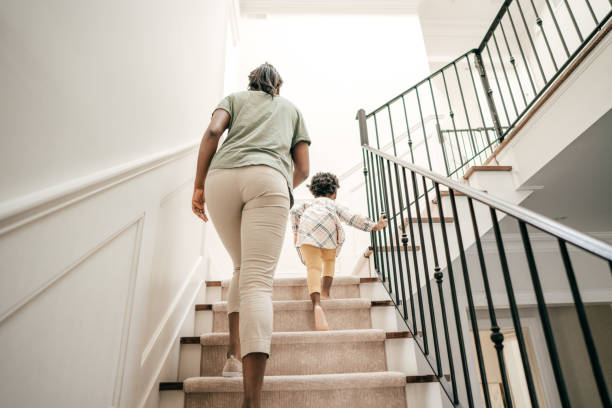 Safety home features Mother and child going upstairs. caution step stock pictures, royalty-free photos & images