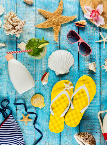 istock Beach accessories placed on blue wooden planks, top view. 953636984