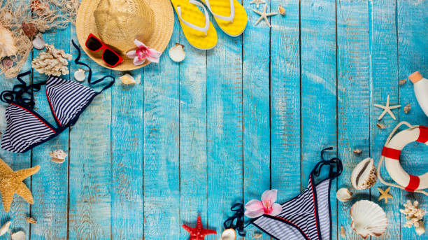 istock Beach accessories placed on blue wooden planks, top view. 953637050