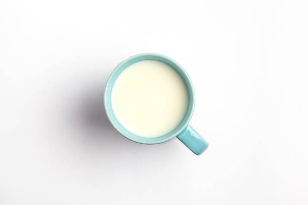 istock Milk in a blue mug isolated on a white background, top view. 953638560
