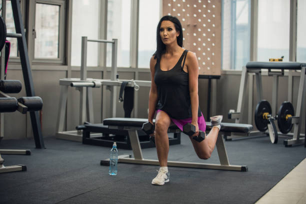 istock Woman workout with dumbbell in gym 953646980