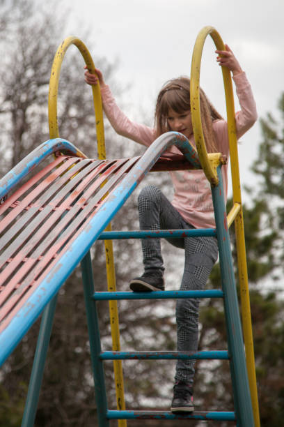 istock Girl climbing the slide 953647552