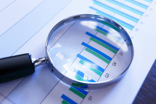 istock Magnifying Glass On Top Of Bar Chart Showing Positive Performance 953652188