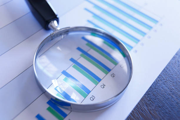 istock Magnifying Glass On Top Of Bar Chart Showing Positive Performance 953652224