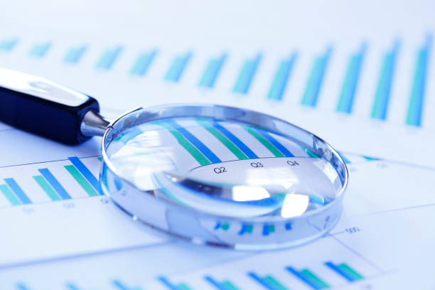 istock Magnifying Glass On Top Of Bar Chart Showing Positive Performance 953652276