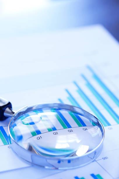 istock Magnifying Glass On Top Of Bar Chart Showing Positive Performance 953652278