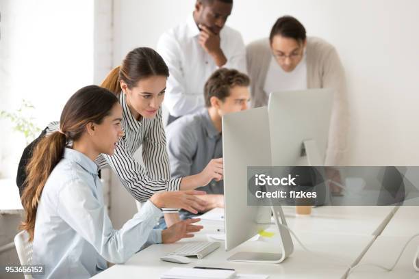 Executive Mentor Explaining Young Intern Or New Employee Online Task Stock Photo - Download Image Now