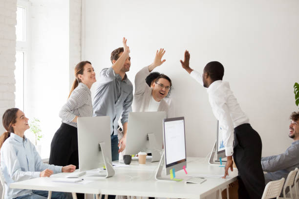 istock Happy multi-ethnic team giving high five together celebrating corporate success 953656188