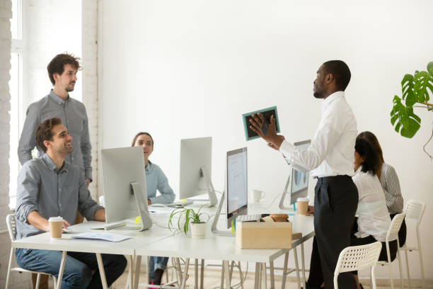 istock New african employee unpacking talking on first office working day 953656246