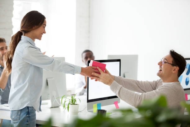 Friendly team congratulating colleague giving present gift, happy birthday concept