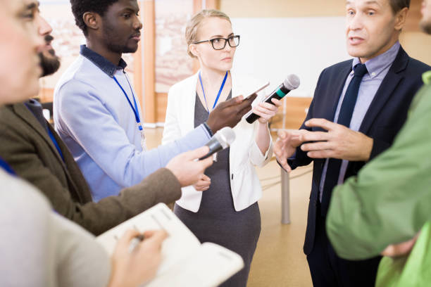 istock Group of Reporters Taking Interview 953657312